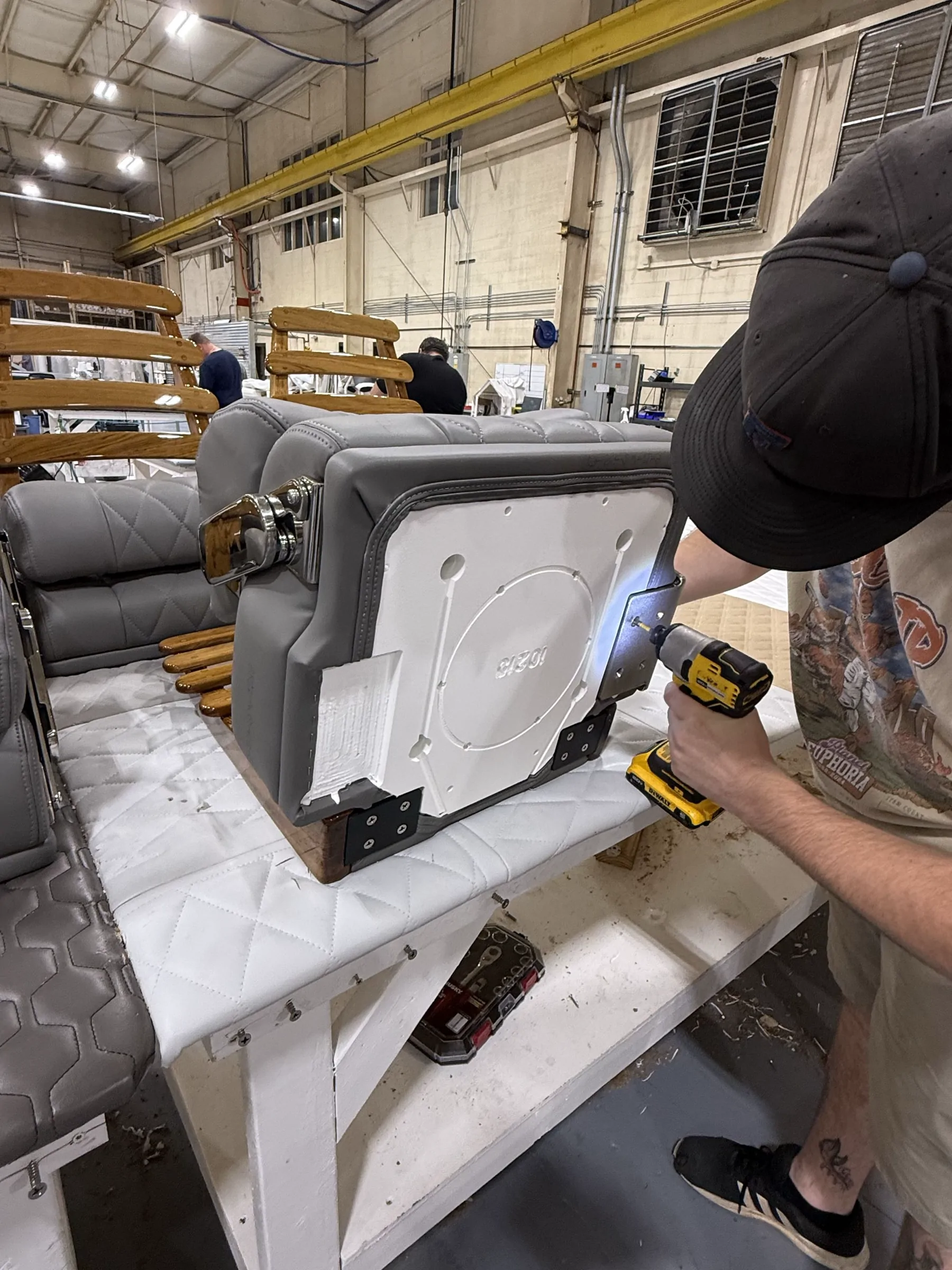 Craftsperson assembling a premium marine seat prototype