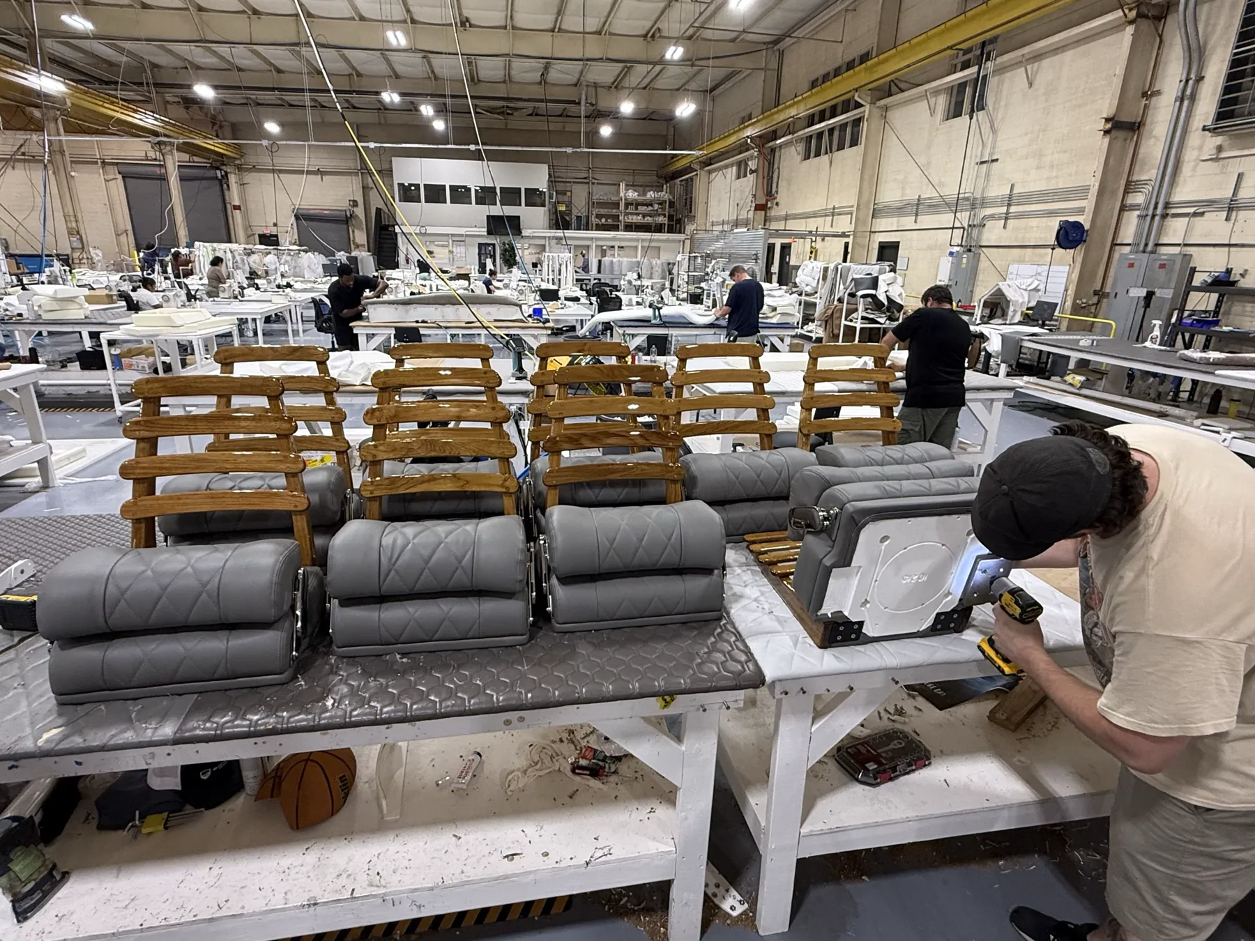 Premium gray marine seats and teak ladder backs in production